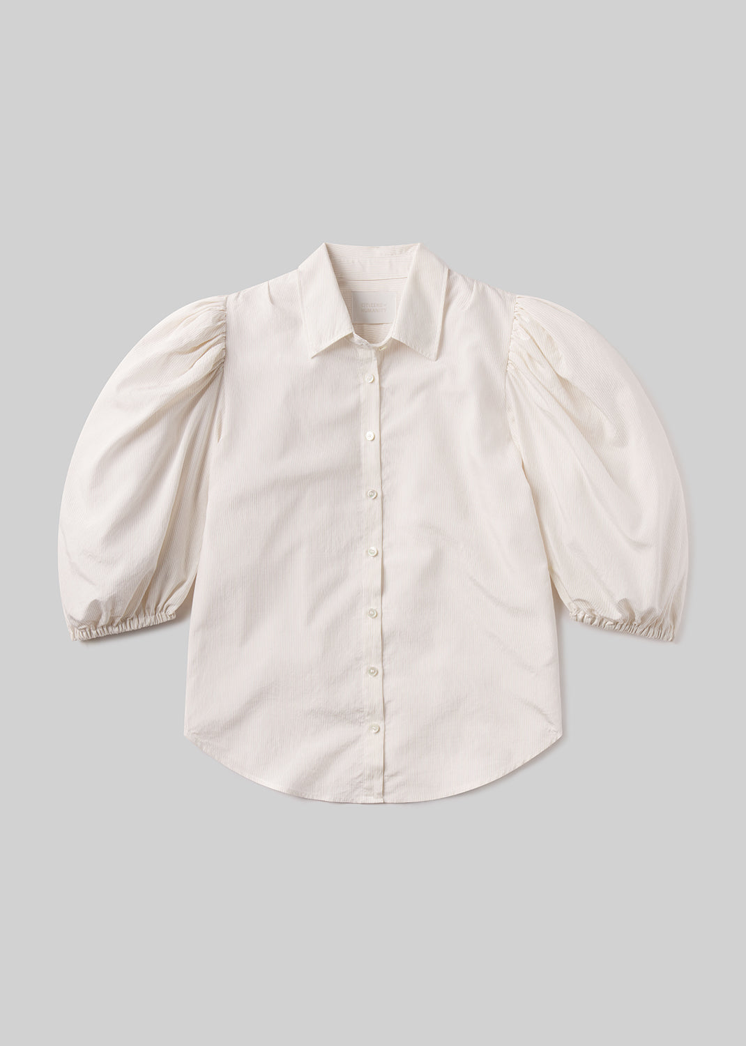 White blouse with puff sleeves on a gray background