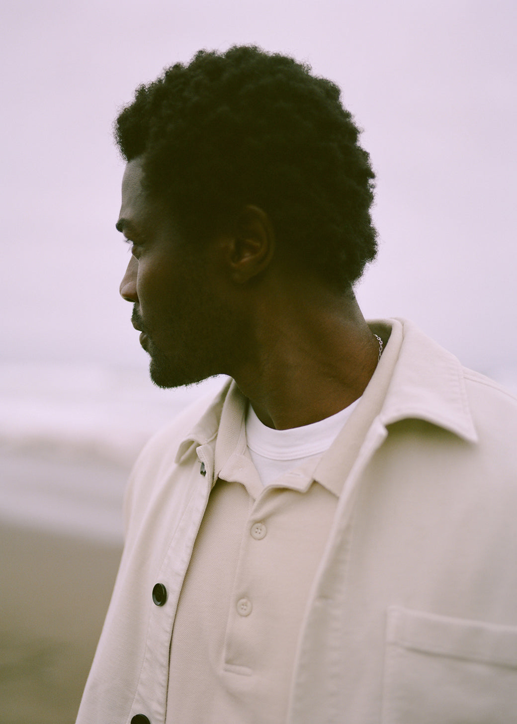 A man wearing Beau in Carob, Workshirt in Canvas, Long Sleeve Banded Polo in Almond, and Everyday Short Sleeve Tee in White 