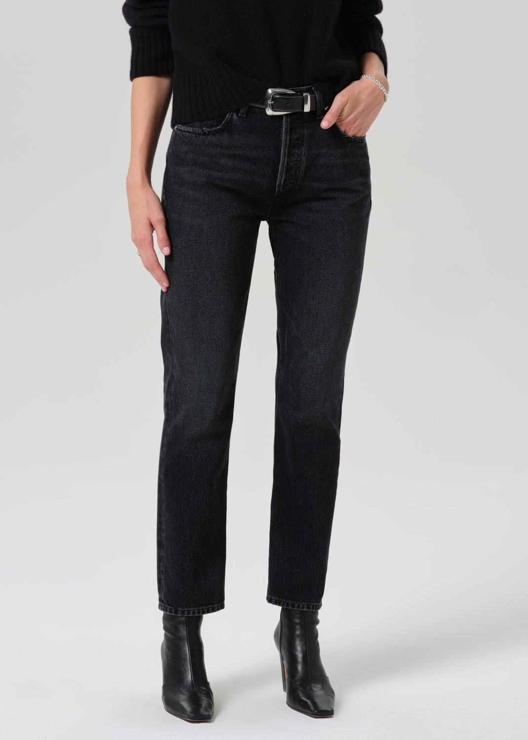Close up of black pants on a grey background