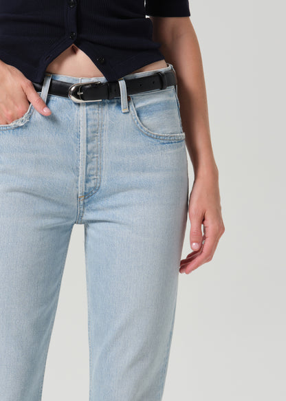 Close up shot of light blue pants with black belt on a grey background