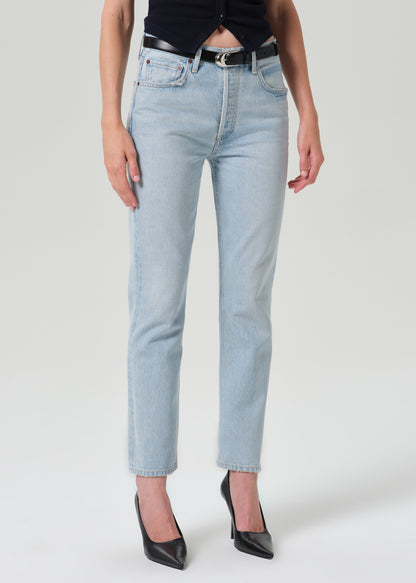 Person wearing blue pants on a grey background