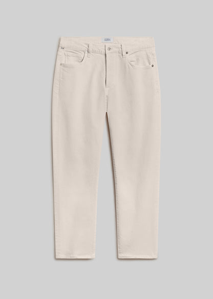 Cream straight leg jeans with a classic five-pocket design, belt loops, and button and zipper closure, front flat lay view on a grey background.