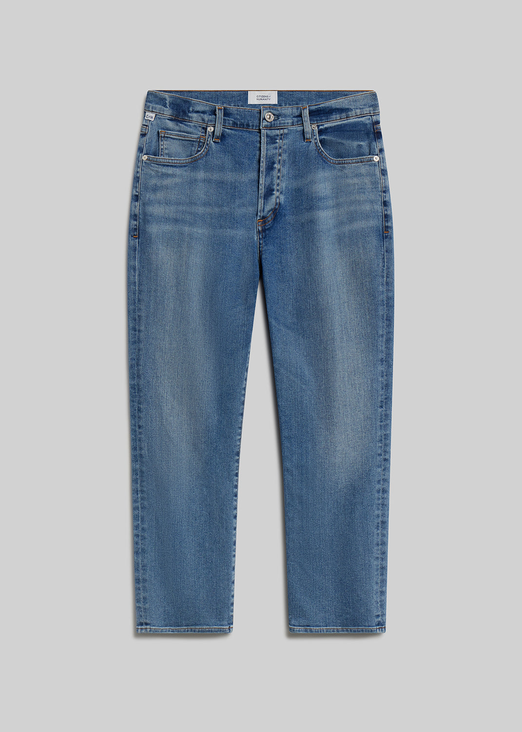 Medium blue straight-leg jeans on grey background