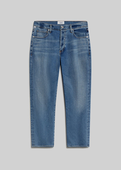 Medium blue straight-leg jeans on grey background