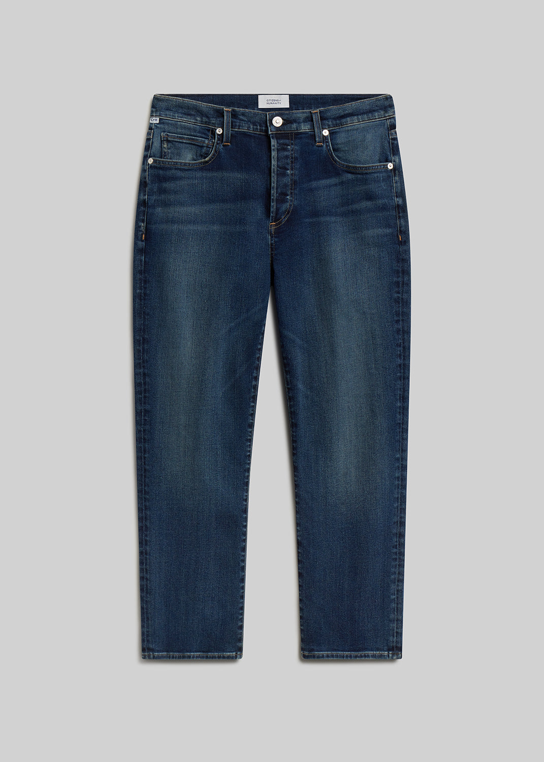 Dark blue straight-leg jeans on grey background