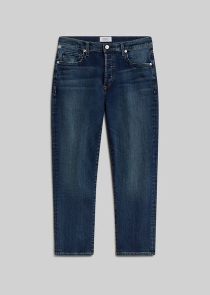Dark blue straight-leg jeans on grey background