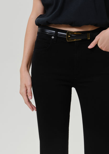 Close-up of black straight leg pants on a grey background.