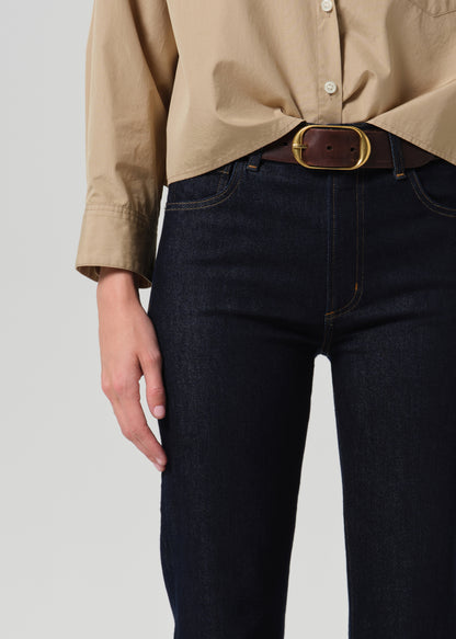 Close up of dark blue jeans on a grey background