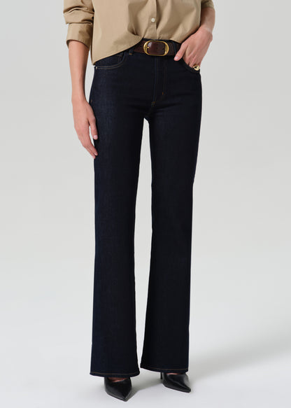 Close up of dark blue jeans on a grey background