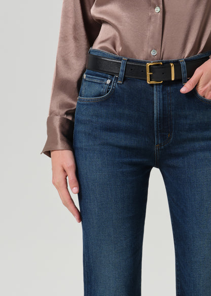 Close up of blue jeans on a grey background