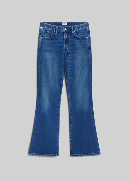 Medium blue bootcut jeans on grey background