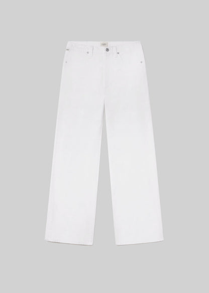 White wide leg jeans with a classic five-pocket design, belt loops, and button and zipper closure, front flat lay view on a grey background.
