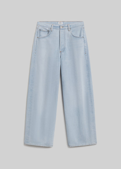 Light blue wide-leg jeans on grey background