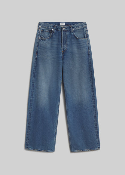 Medium blue wide-leg jeans on grey background