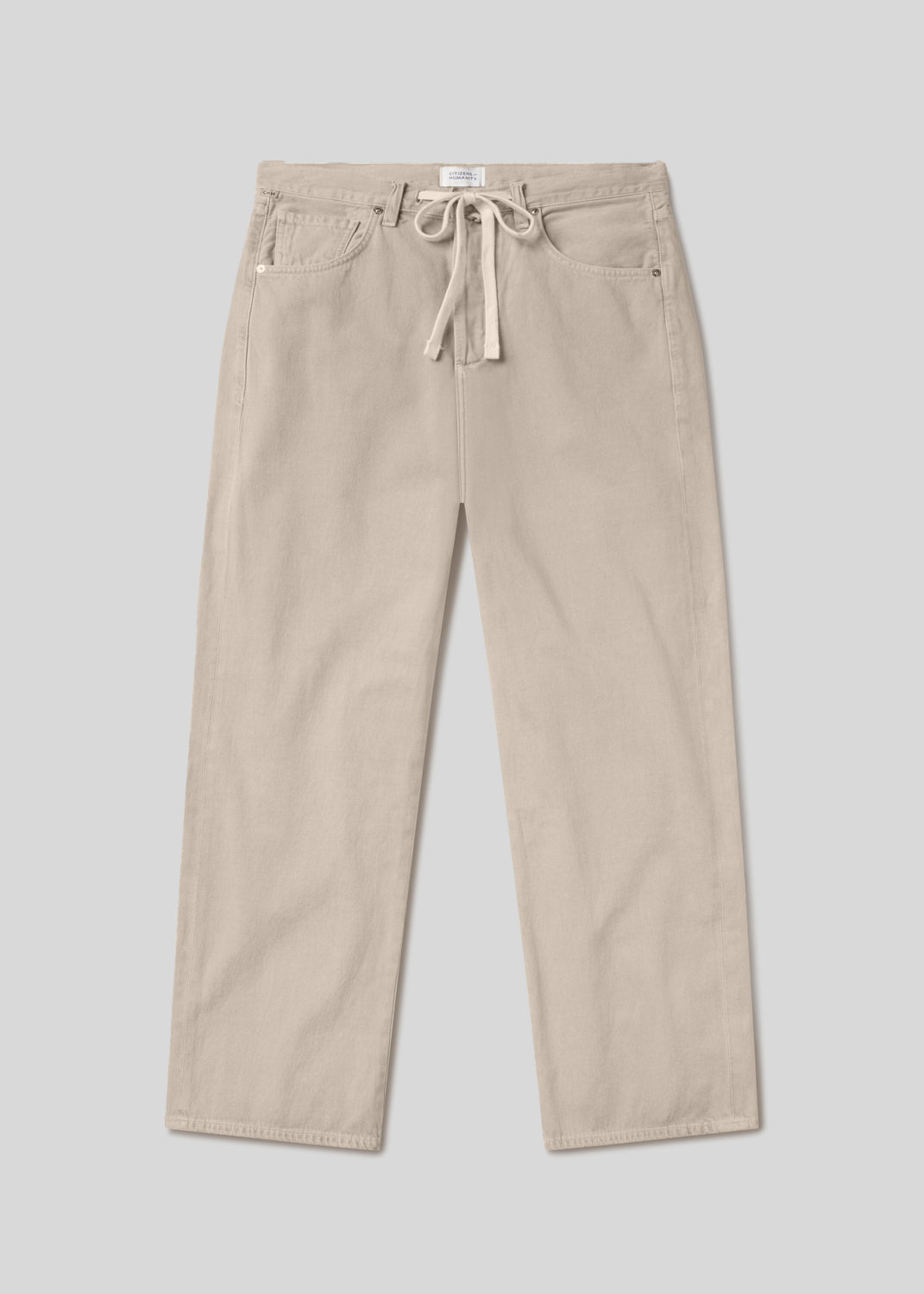 Light beige straight leg trousers with a drawstring waist, five-pocket design, belt loops, and button closure, front flat lay view on a grey background.