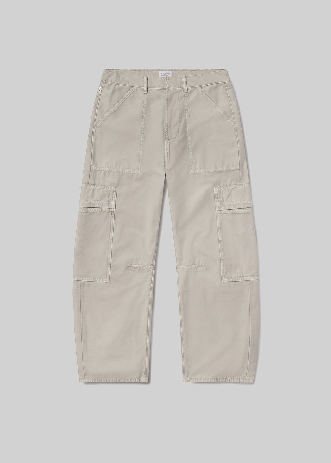 Light beige cargo pants with a relaxed fit, tapered leg, front utility pockets, side cargo pockets, belt loops, and zipper fly closure, front flat lay view on a grey background.