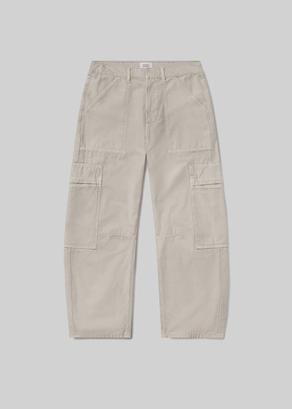 Light beige cargo pants with a relaxed fit, tapered leg, front utility pockets, side cargo pockets, belt loops, and zipper fly closure, front flat lay view on a grey background.