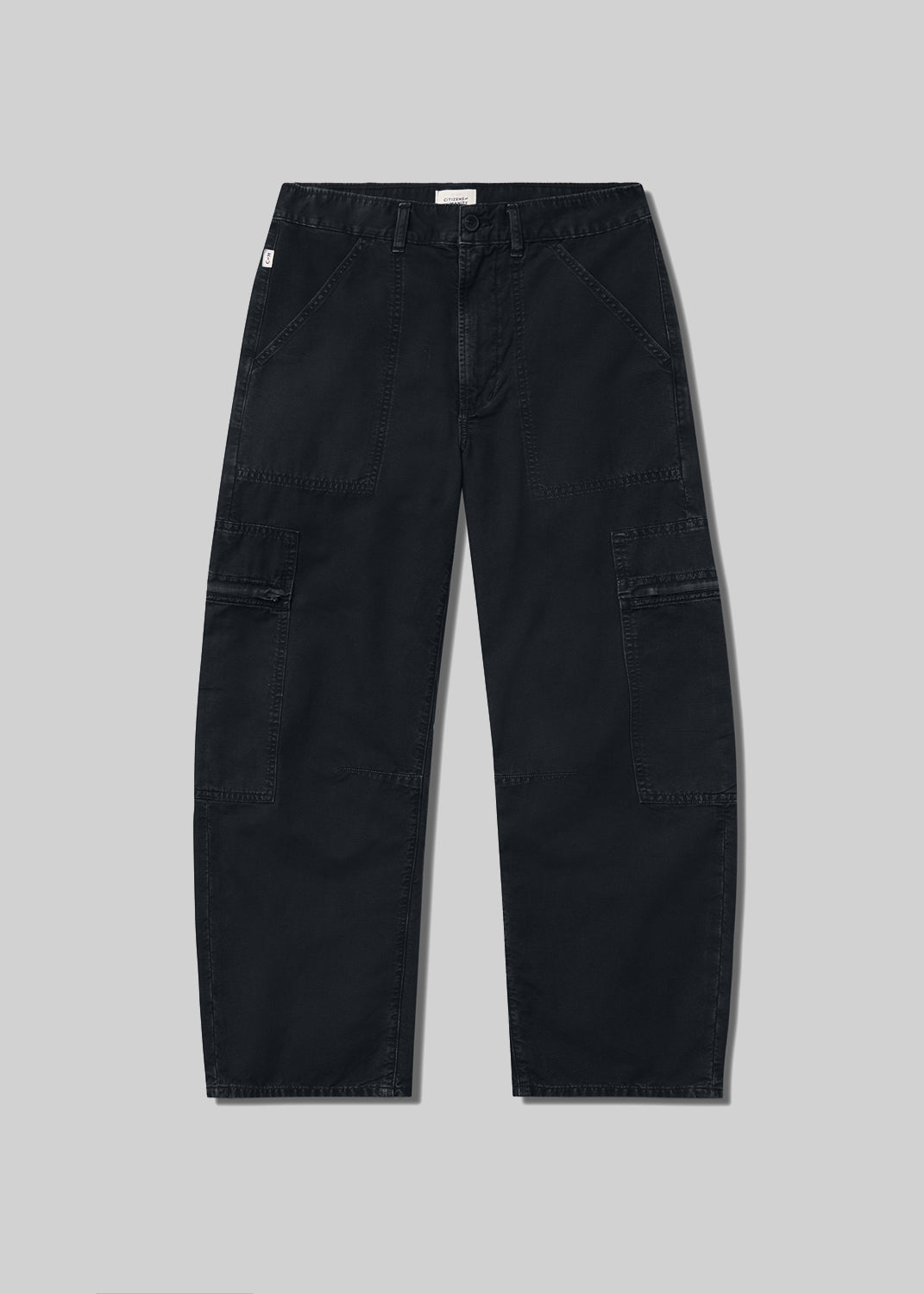 Black cargo pants with a relaxed fit, tapered leg, front utility pockets, side cargo pockets, belt loops, and zipper fly closure, front flat lay view on a grey background.