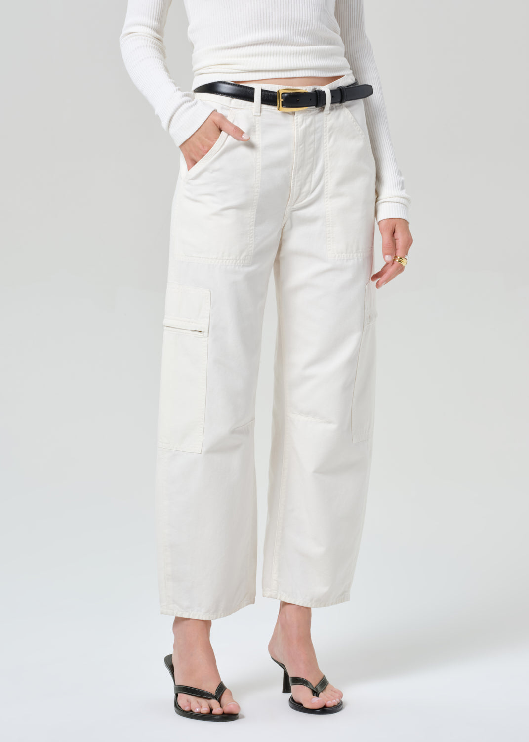 Person wearing white pants and a white top on a plain background