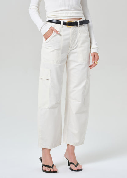 Person wearing white pants and a white top on a plain background