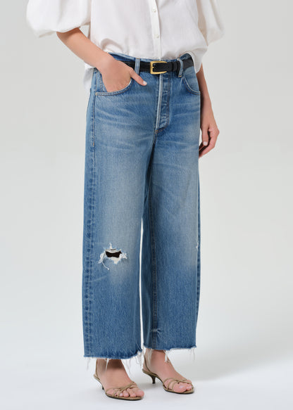 Person wearing blue jeans with a white background