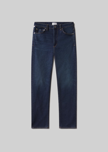 Pair of dark blue jeans on a light gray background