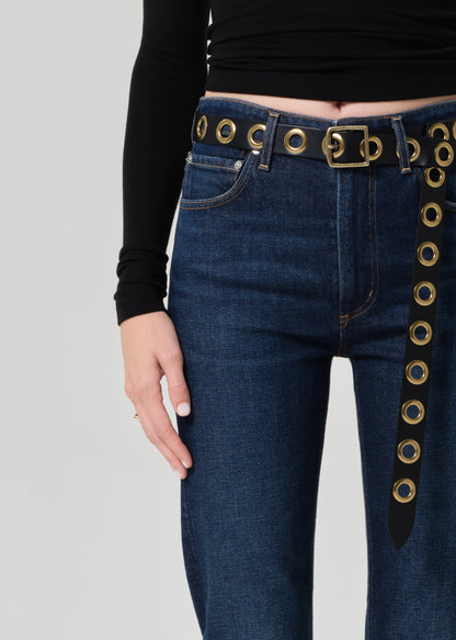 Blue jeans with decorative gold accents on a plain background