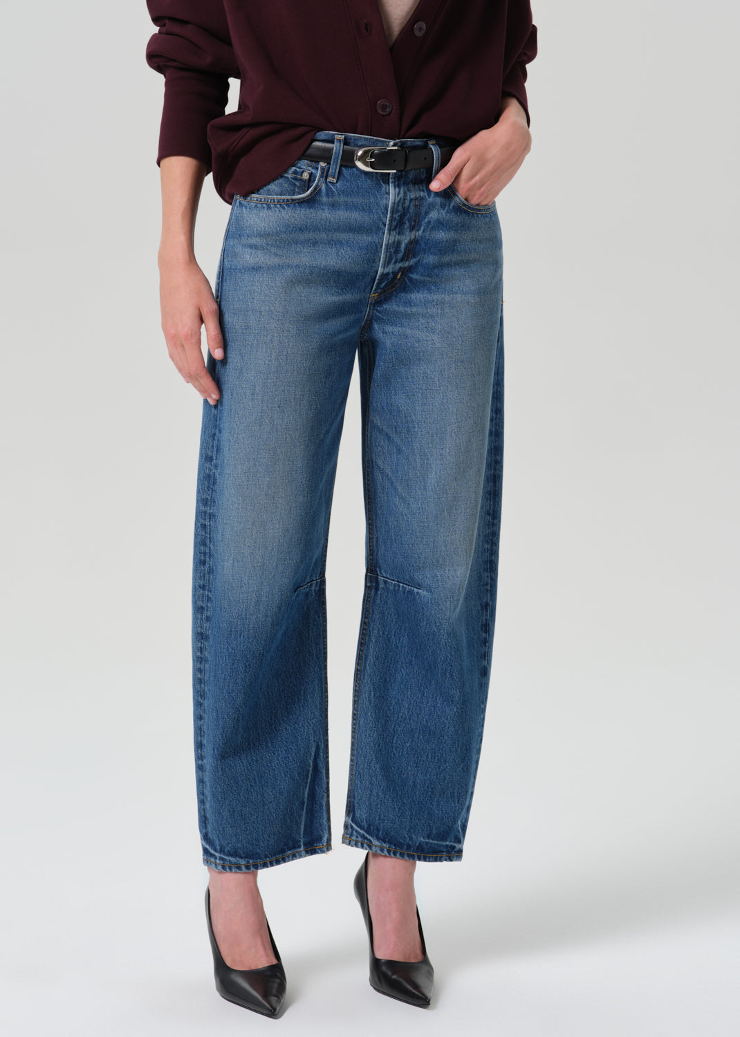 Person wearing a blue pant on a grey background