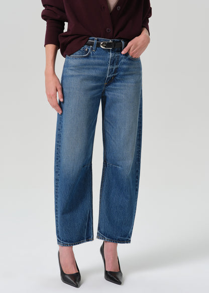 Person wearing a blue pant on a grey background