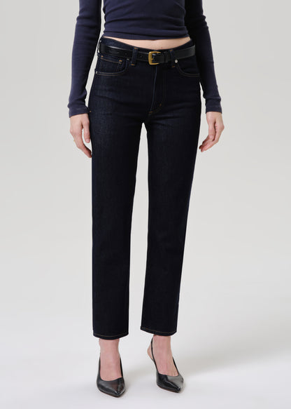 Person wearing black jeans and a dark top on a grey background