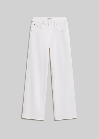 Soft white wide-leg jeans on grey background