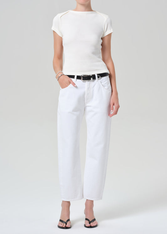 Person wearing a white t-shirt and white pants on a plain background