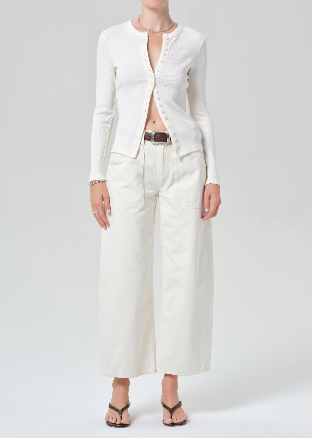 Person wearing white cardigan with off-white cargo pants