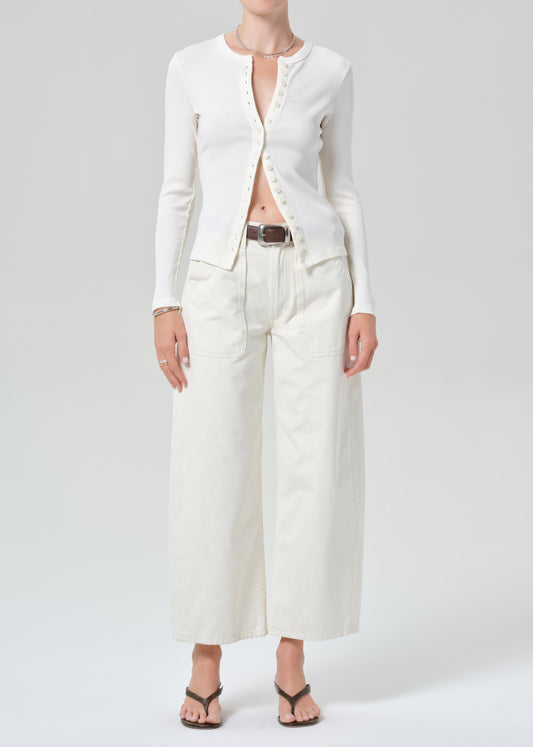 Person wearing white cardigan with off-white cargo pants