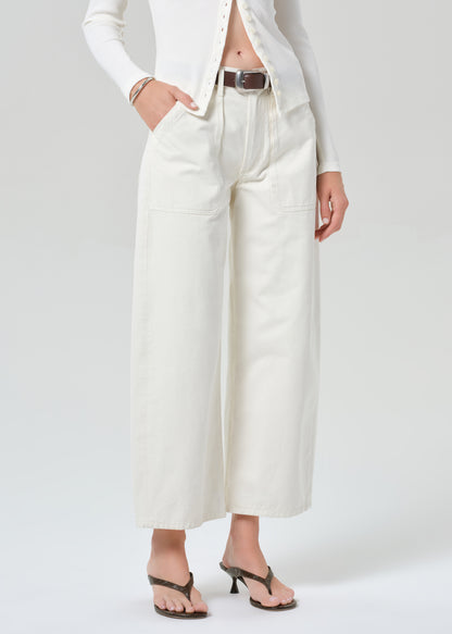 Person wearing white cardigan with off-white cargo pants