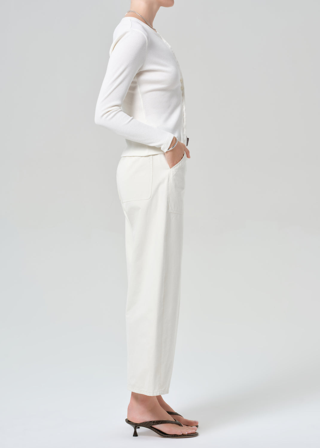 Person wearing white cardigan with off-white cargo pants