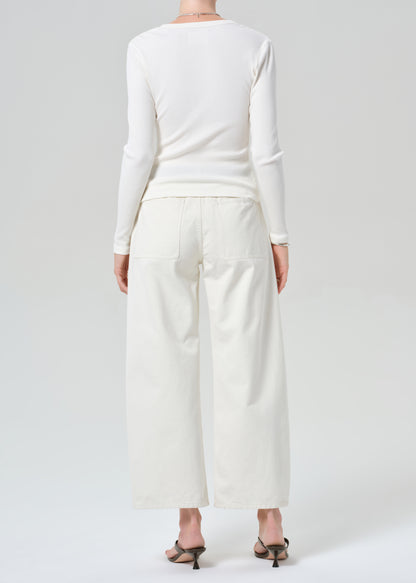 Person wearing white cardigan with off-white cargo pants