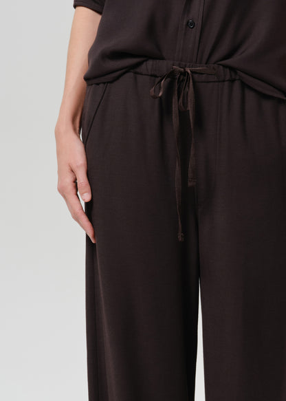 Close up shot of brown pants on a grey background
