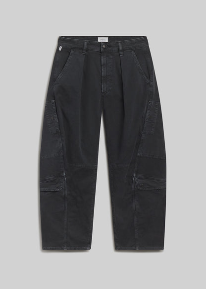 Washed black cargo pants on grey background