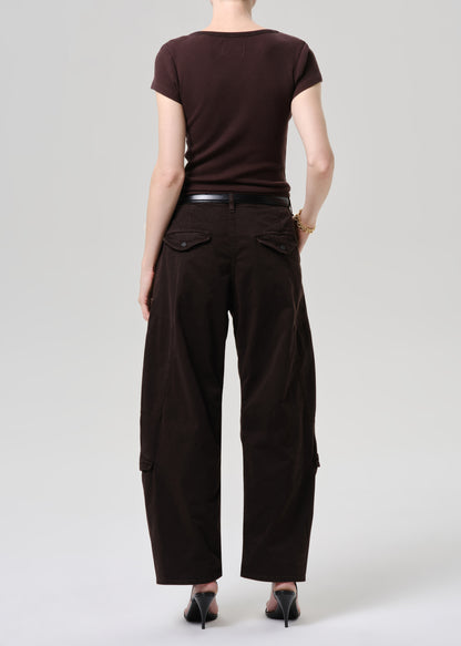 A model shown from the back wearing dark brown wide-leg cargo pants with flap pockets, a dark brown short-sleeve top, a black belt, and black heels, set against a grey background.