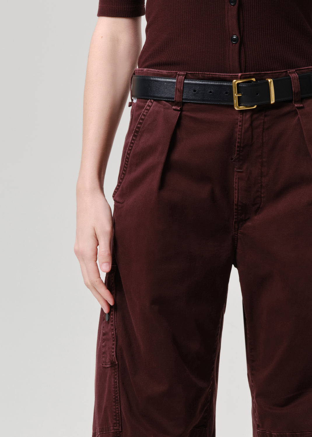 Women wearing mahogany top and cargo pants