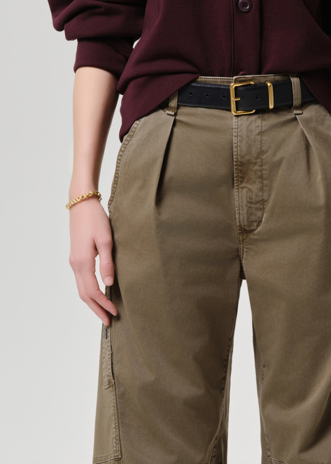 Women wearing mahogany cardigan with army green cargo pants
