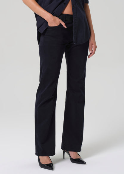 Person wearing navy pants and a dark top on a white background