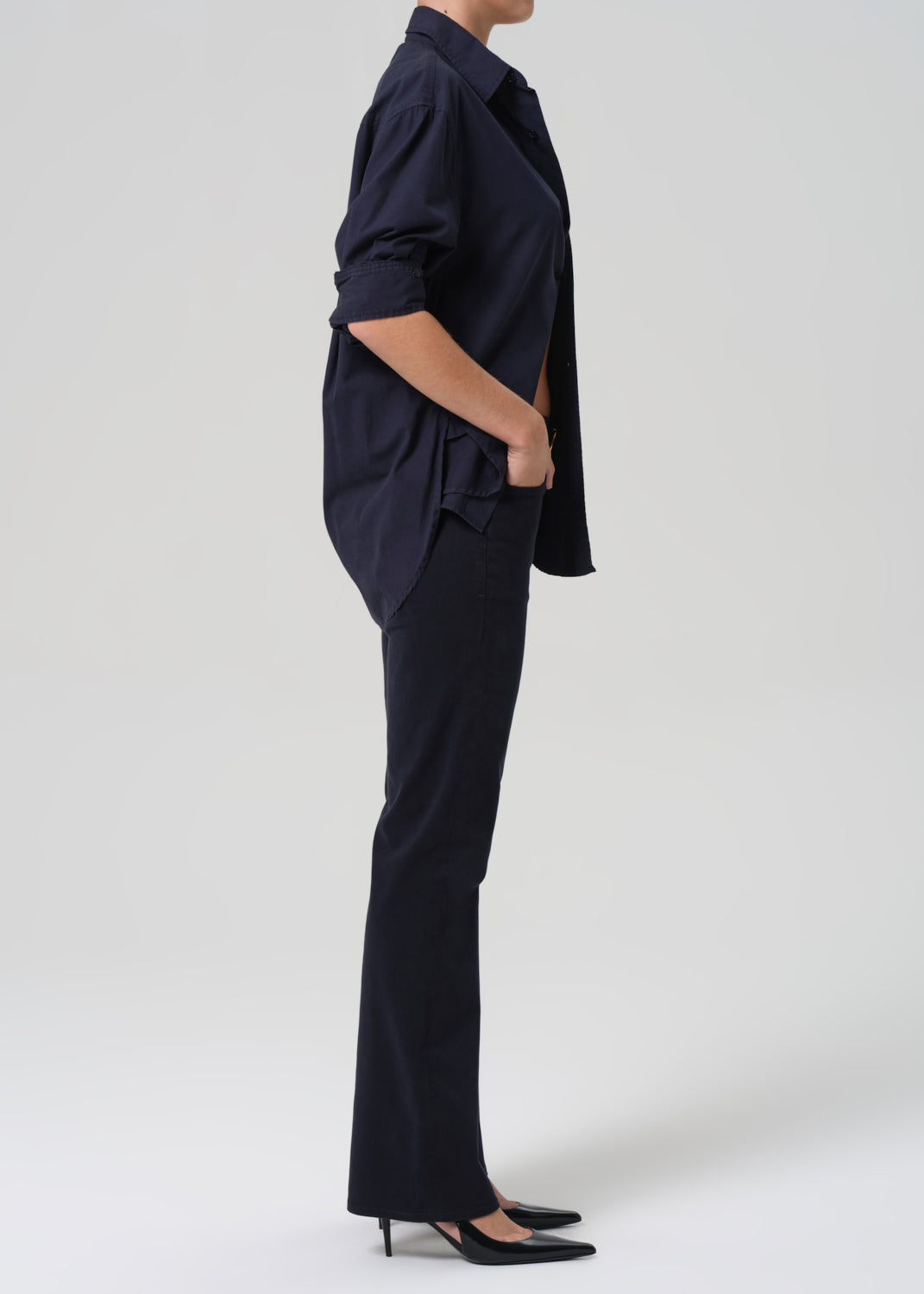 Person wearing a navy blue outfit on a white background