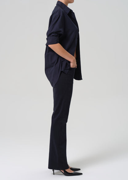 Person wearing a navy blue outfit on a white background