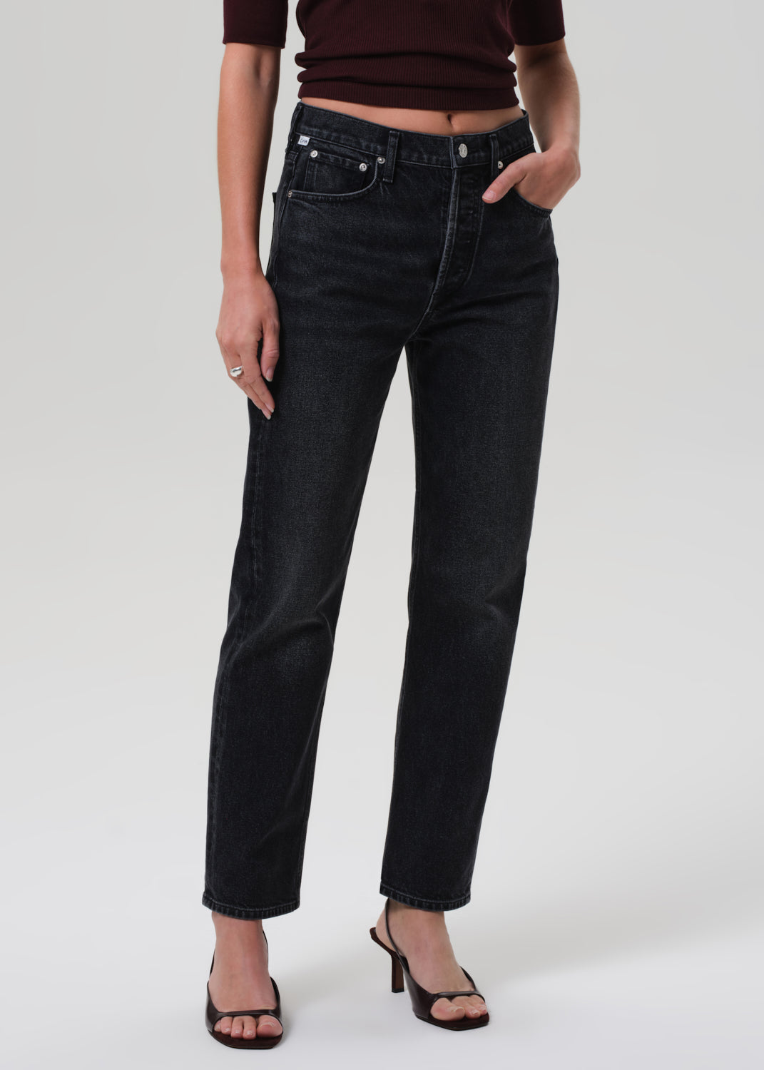 Person wearing black jeans on a white background