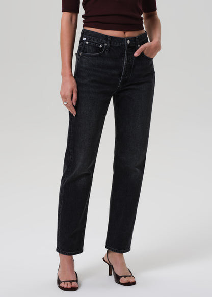 Person wearing black jeans on a white background