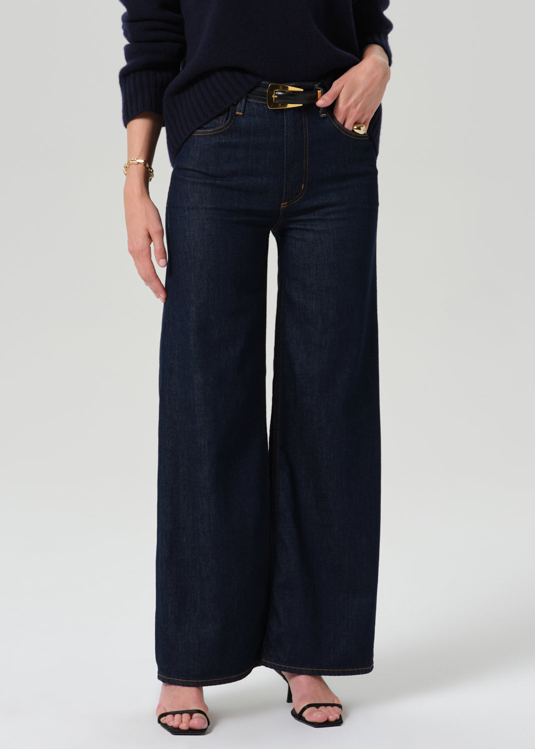 Close up of dark blue pants on a grey background