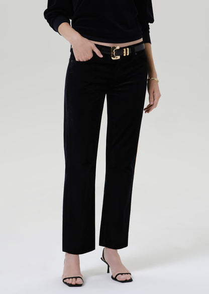 Person wearing black pants and belt on a grey background