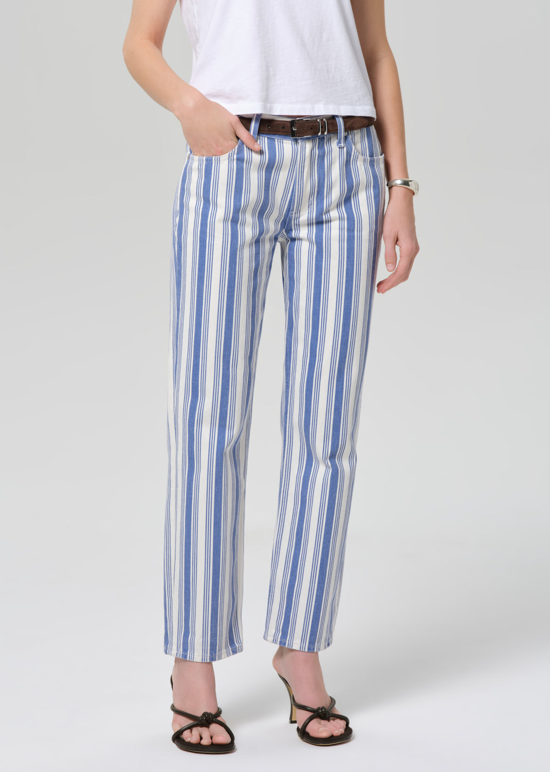Person wearing blue and white striped pants on a plain background